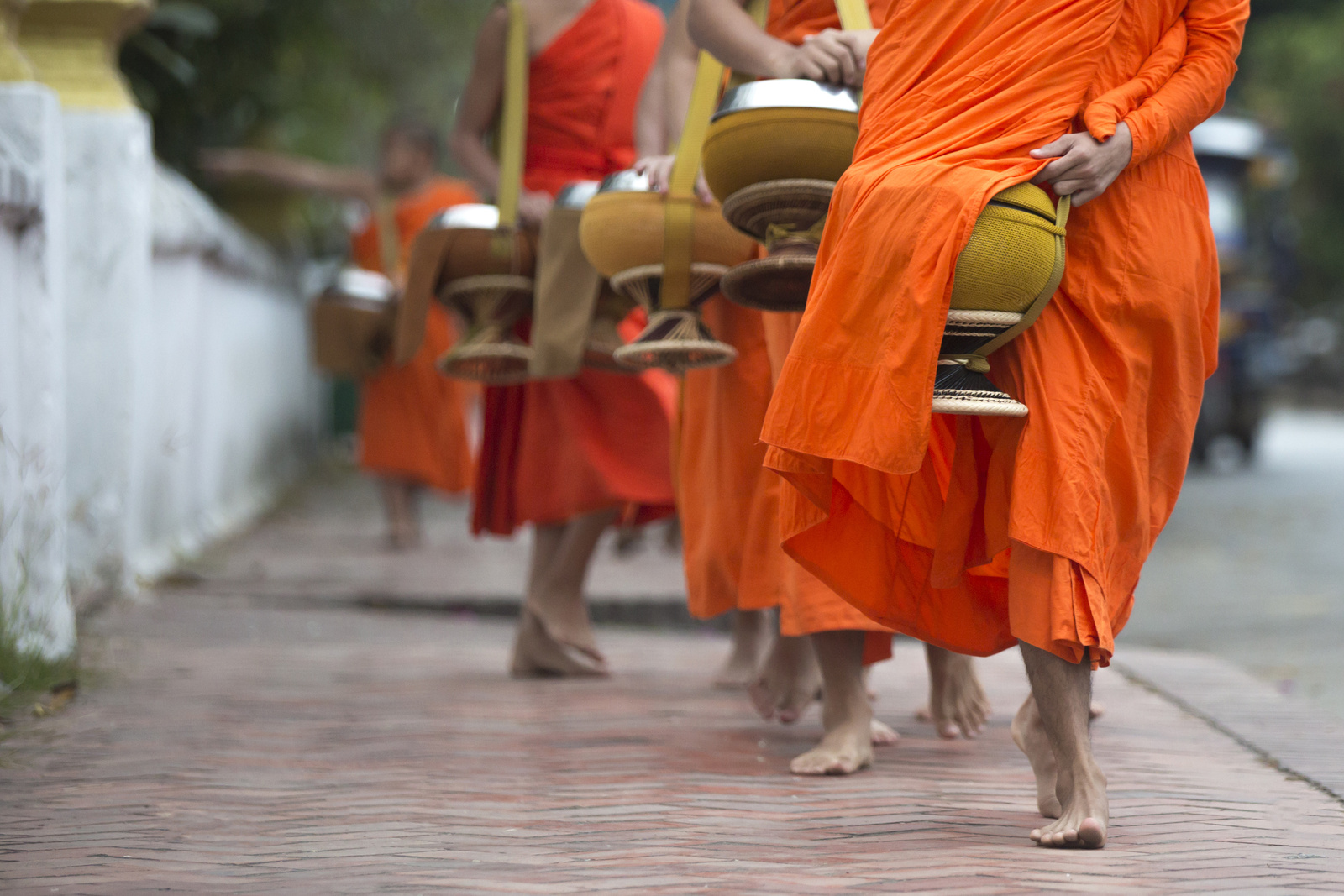 Buddhist monks on everyday morning traditional alms giving in Luang Prabang, Laos.