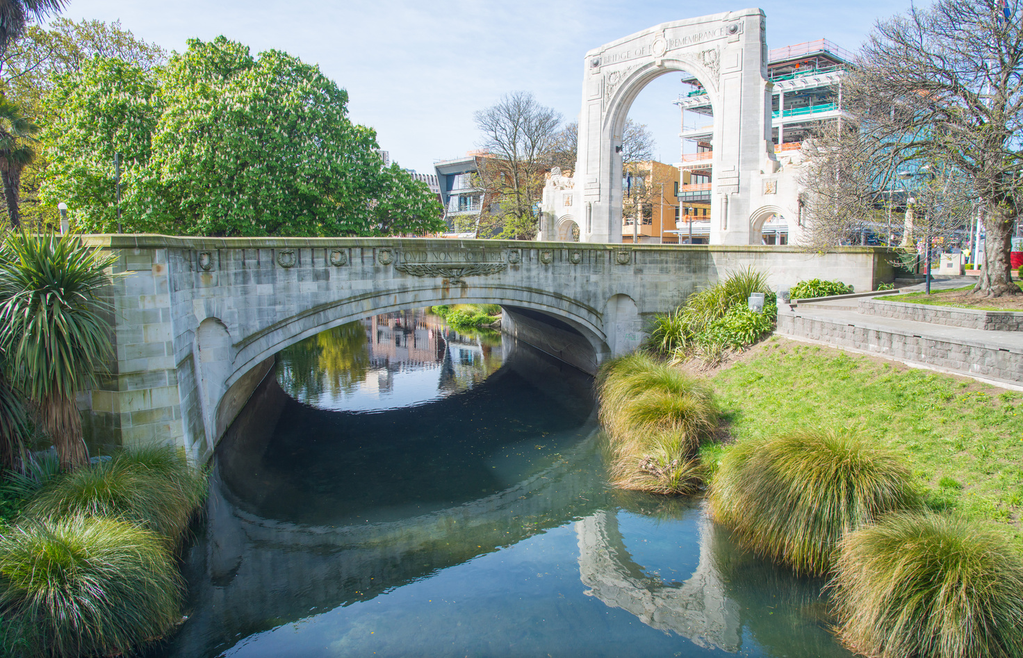 Cityscape of Christchurch downtown and The Bridge of Remembrance reflection on Avon river in Christchurch, New Zealand.